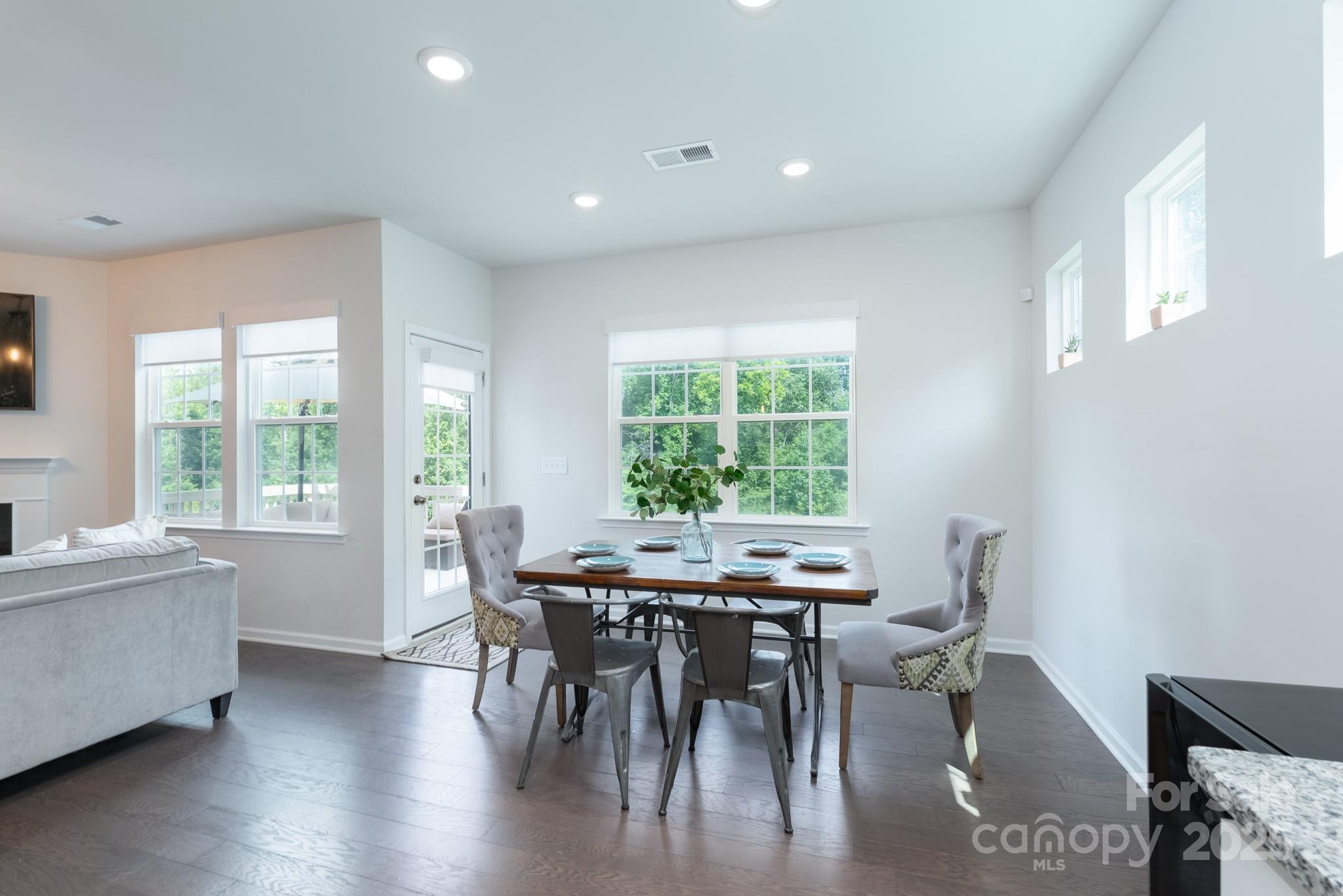 1782 Wildwood Terrace Trail Tega Cay, SC 29708 - Photo 8 of 47 a view of a dining room with furniture and wooden floor