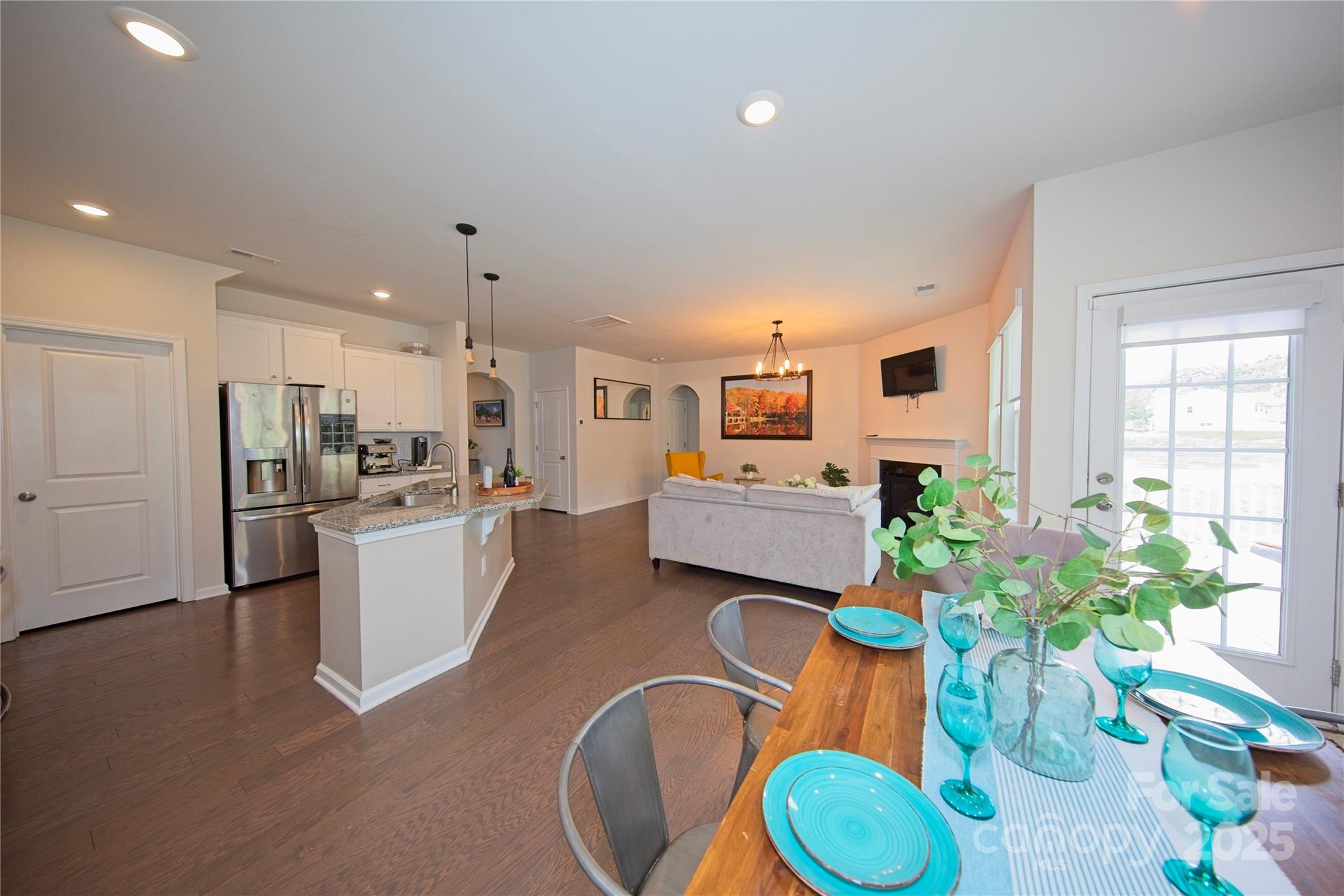 1782 Wildwood Terrace Trail Tega Cay, SC 29708 - Photo 9 of 47 a kitchen with sink refrigerator dining table and chairs