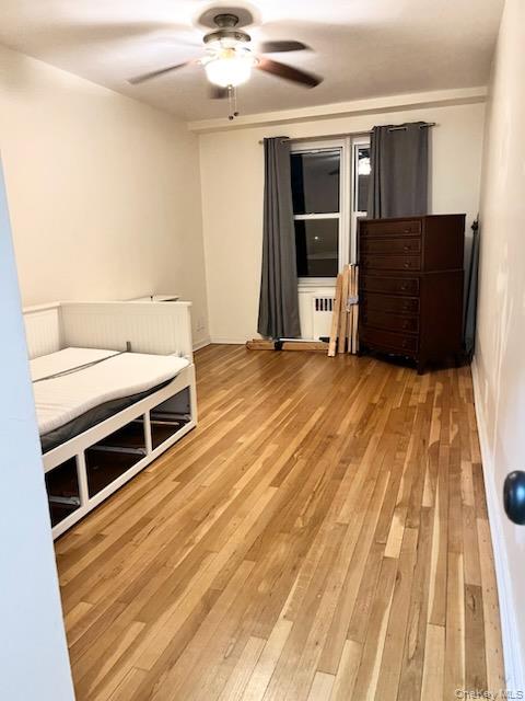 2080 Barnes Avenue, Unit 3B Bronx, NY 10462 - Photo 11 of 16 an empty room with wooden floor and windows