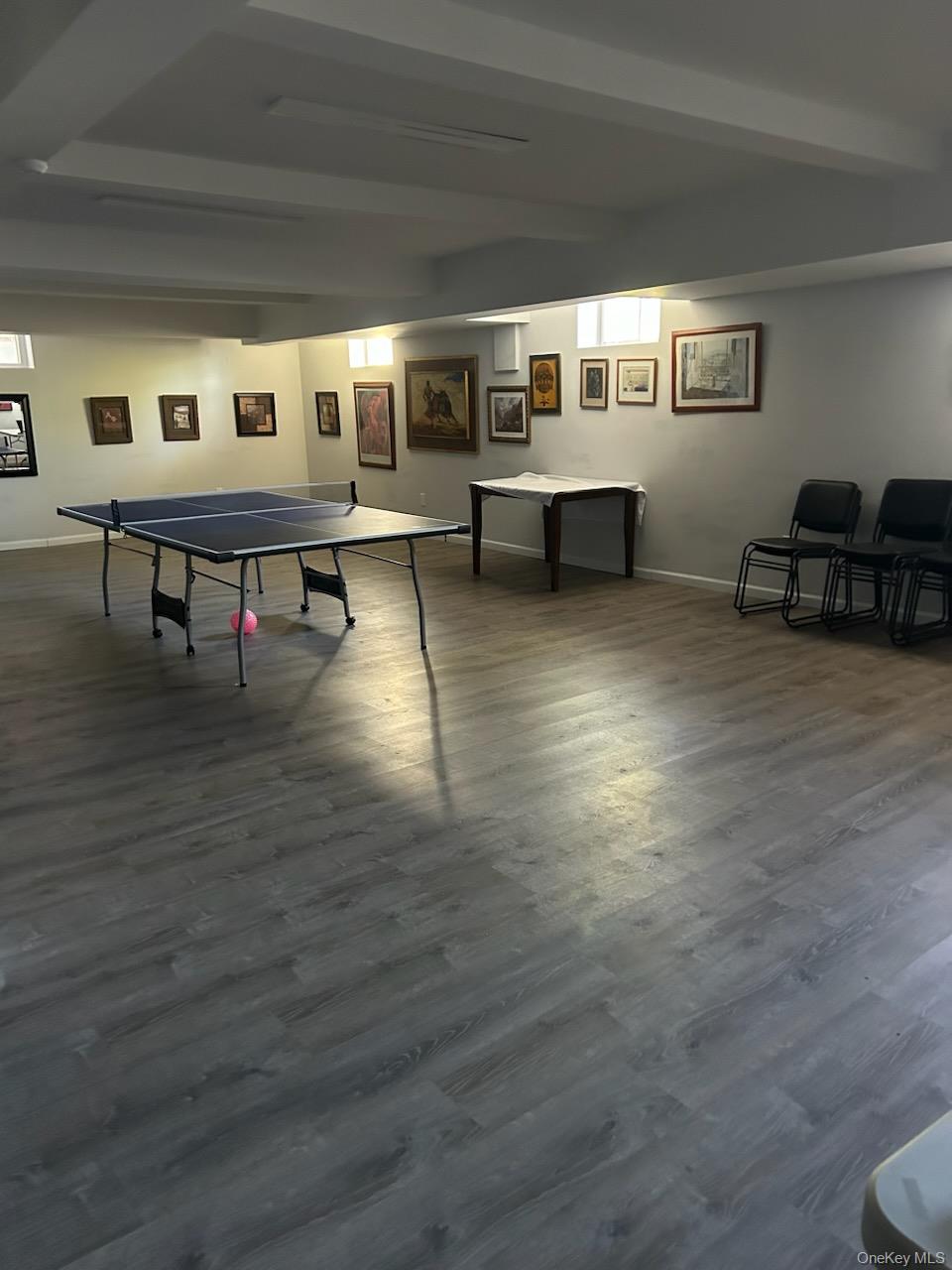 2080 Barnes Avenue, Unit 3B Bronx, NY 10462 - Photo 16 of 16 a living room with couches and pool table with wooden floor