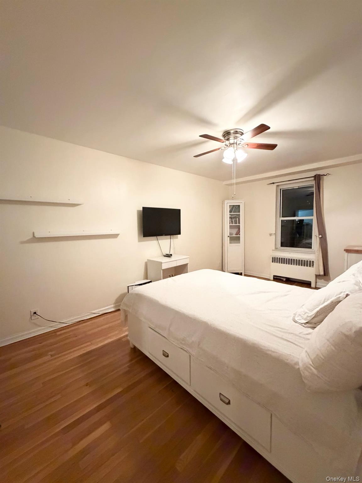 2080 Barnes Avenue, Unit 3B Bronx, NY 10462 - Photo 8 of 16 a spacious bedroom with a bed and a ceiling fan
