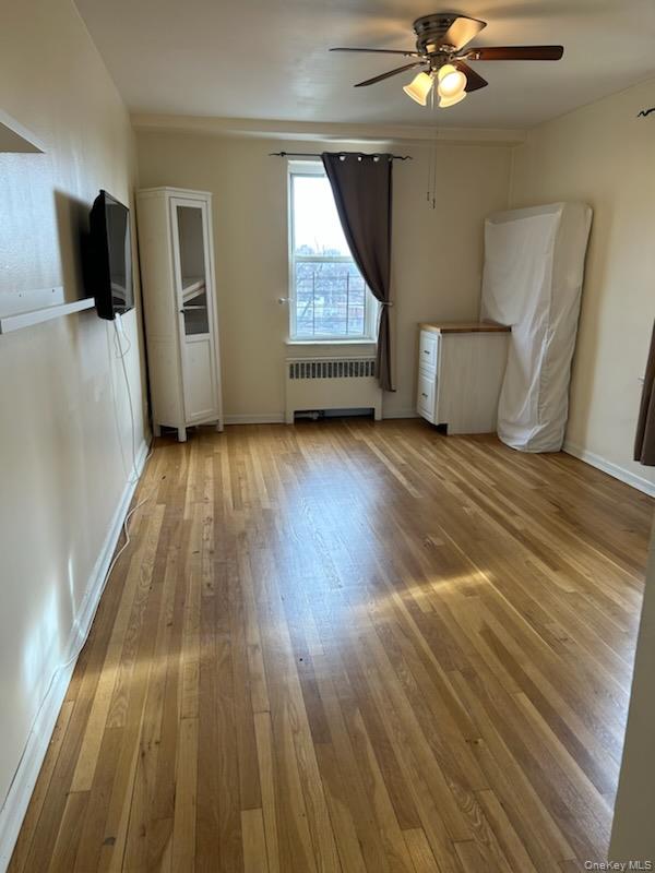 2080 Barnes Avenue, Unit 3B Bronx, NY 10462 - Photo 9 of 16 a view of a livingroom with wooden floor and ceiling fan