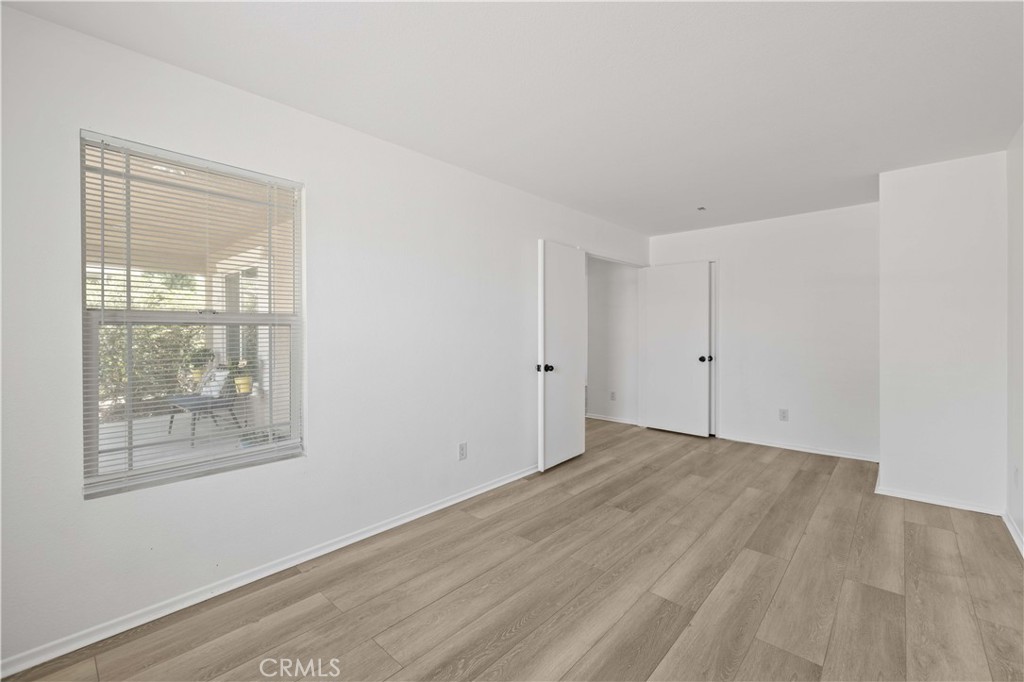 38133 Ranger Drive Palmdale, CA 93552 - Photo 17 of 29 a view of an empty room with wooden floor and a window