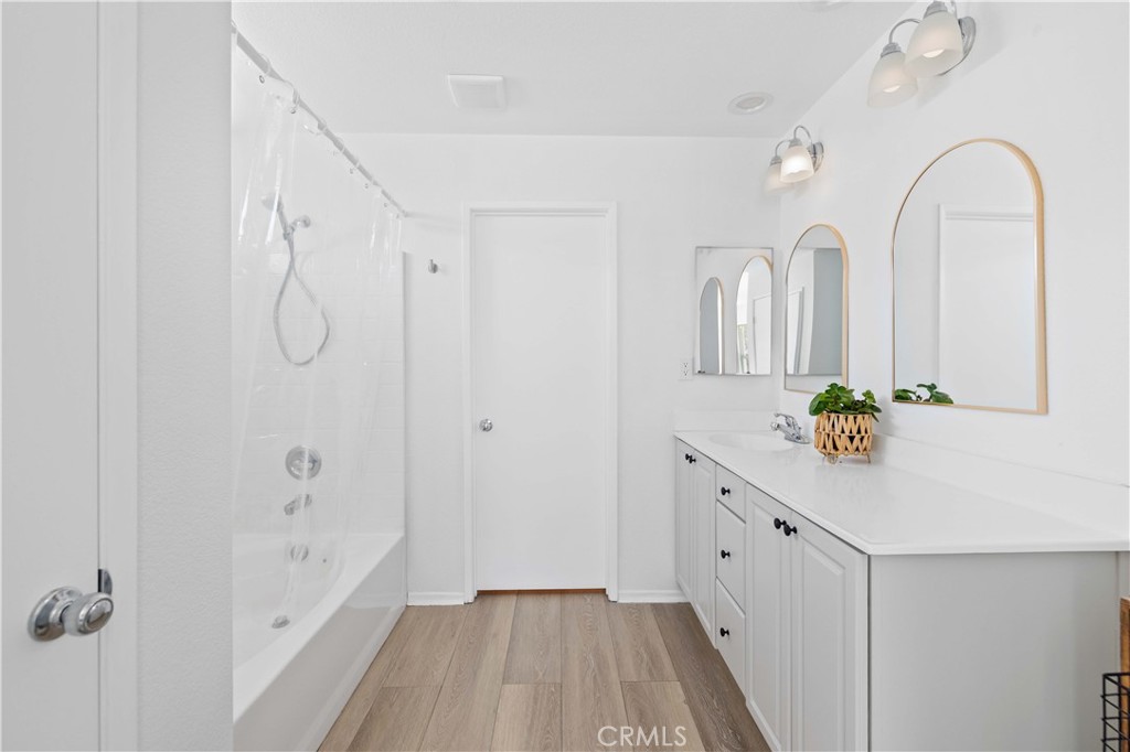 38133 Ranger Drive Palmdale, CA 93552 - Photo 25 of 29 a bathroom with a granite countertop sink a toilet and a shower