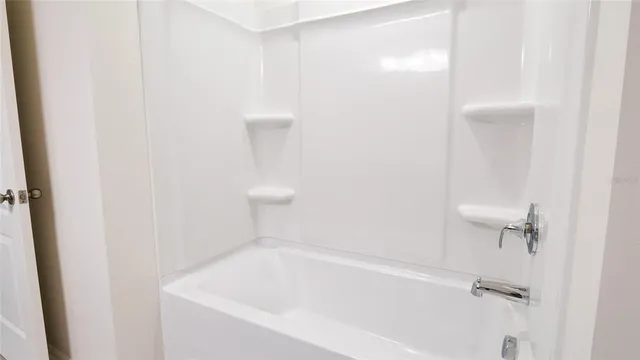 a white bath tub sitting in a bathroom