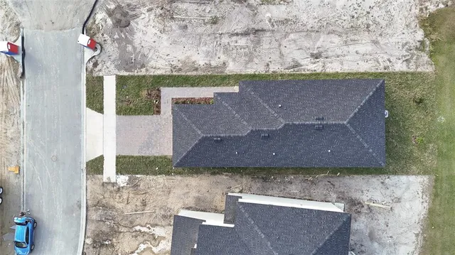 an aerial view of a house with a yard