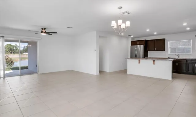 a view of a kitchen with a sink and a chandelier fan
