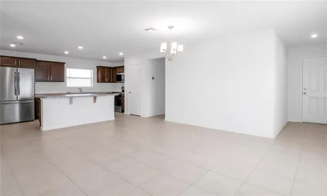 a view of a kitchen with a sink and refrigerator