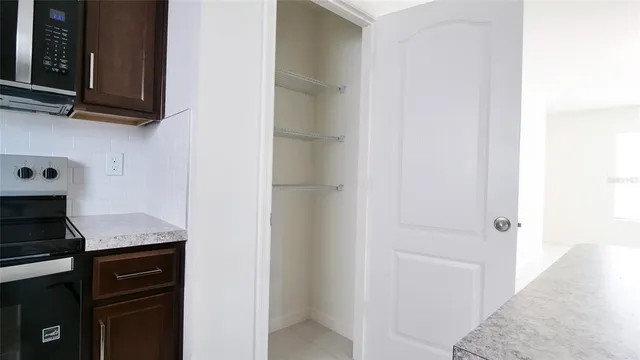 a kitchen with a refrigerator and cabinets