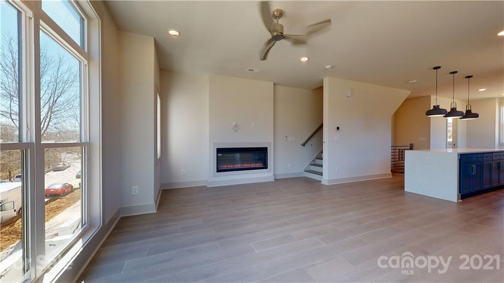 2335 Wesley Village Road, Unit 34 Charlotte, NC 28208 - Photo 16 of 40 a view of empty room with a fireplace and wooden floor