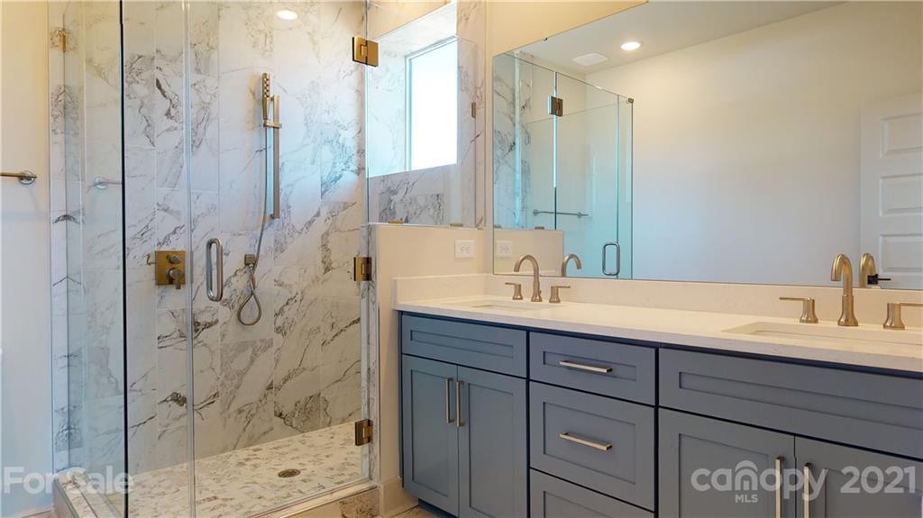 2335 Wesley Village Road, Unit 34 Charlotte, NC 28208 - Photo 18 of 40 a bathroom with a double vanity sink mirror and shower