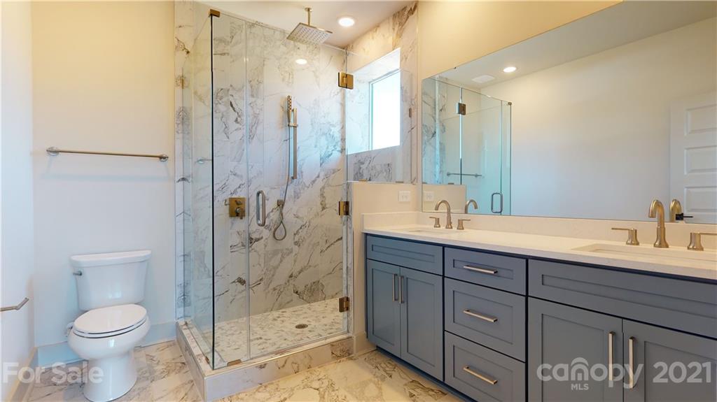 2335 Wesley Village Road, Unit 34 Charlotte, NC 28208 - Photo 20 of 40 a bathroom with a sink a toilet and shower