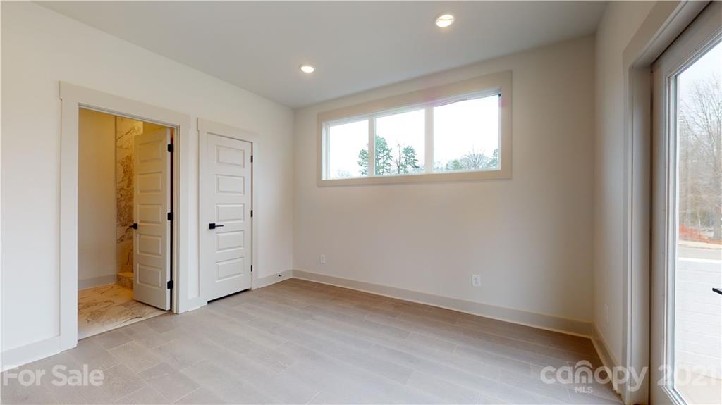 2335 Wesley Village Road, Unit 34 Charlotte, NC 28208 - Photo 25 of 40 an empty room with windows and closet