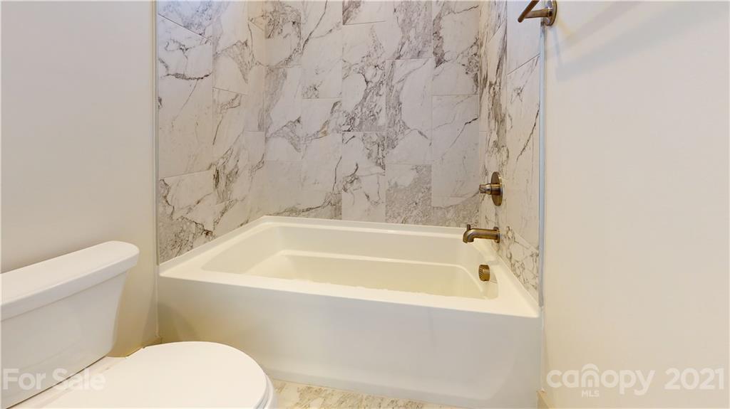 2335 Wesley Village Road, Unit 34 Charlotte, NC 28208 - Photo 27 of 40 a bathroom with a bathtub and toilet