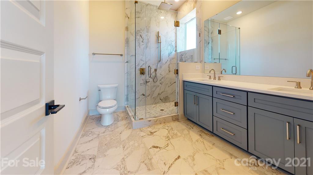 2335 Wesley Village Road, Unit 34 Charlotte, NC 28208 - Photo 28 of 40 a spacious bathroom with a bathtub shower sink mirror and toilet