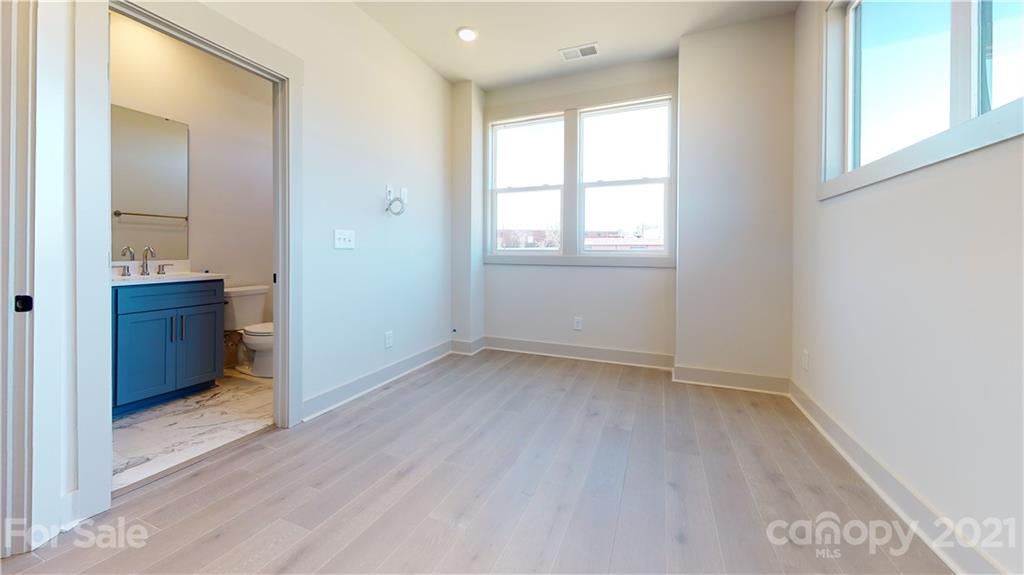 2335 Wesley Village Road, Unit 34 Charlotte, NC 28208 - Photo 32 of 40 an empty room with windows and cabinet