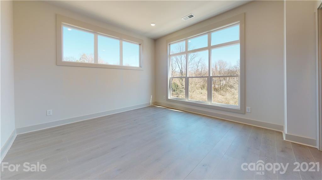 2335 Wesley Village Road, Unit 34 Charlotte, NC 28208 - Photo 33 of 40 an empty room with wooden floor and windows