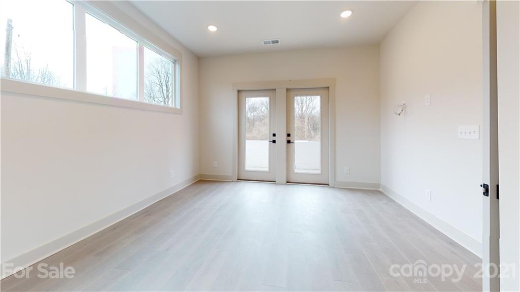 2335 Wesley Village Road, Unit 34 Charlotte, NC 28208 - Photo 34 of 40 an empty room with wooden floor and windows