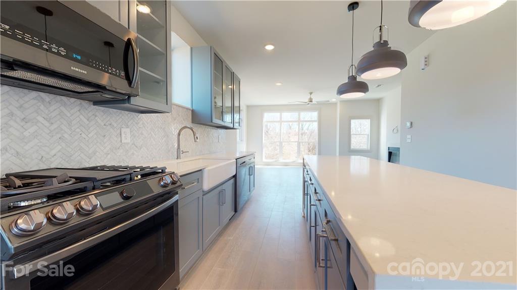 2335 Wesley Village Road, Unit 34 Charlotte, NC 28208 - Photo 6 of 40 a kitchen with stove and cabinets