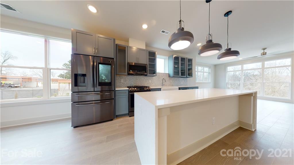 2335 Wesley Village Road, Unit 34 Charlotte, NC 28208 - Photo 7 of 40 a large kitchen with stainless steel appliances kitchen island a large island in the middle