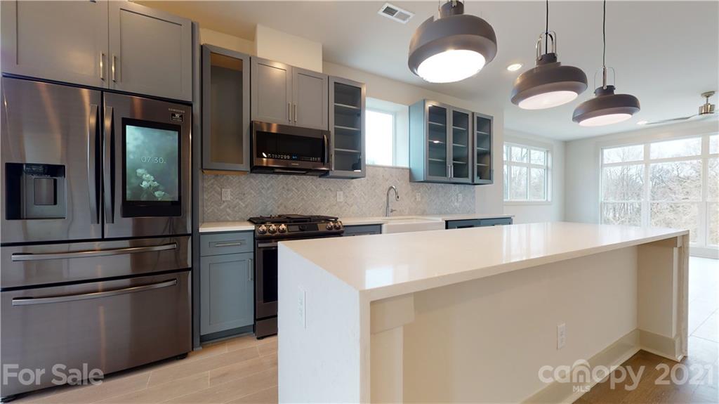2335 Wesley Village Road, Unit 34 Charlotte, NC 28208 - Photo 9 of 40 a kitchen with stainless steel appliances granite countertop a sink a stove and a refrigerator