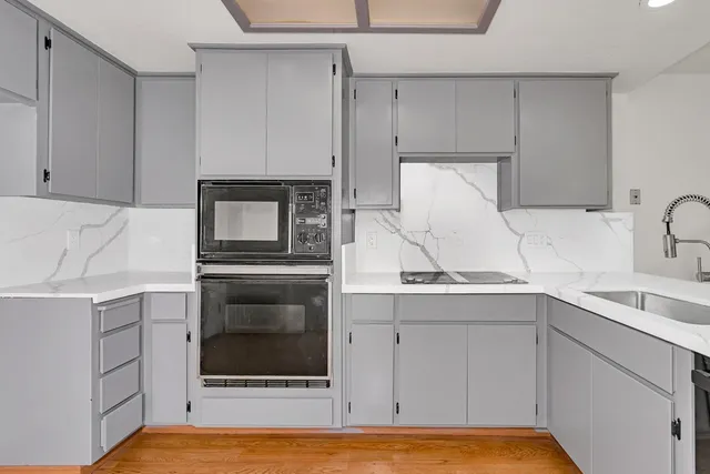 a kitchen with a sink and cabinets