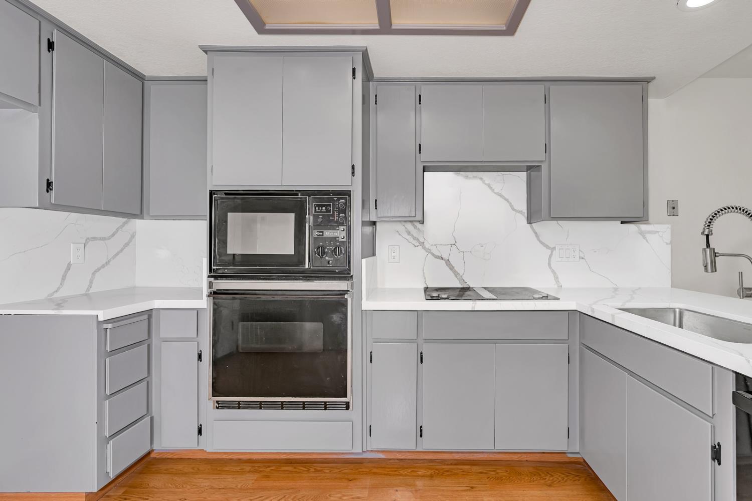a kitchen with a sink and cabinets