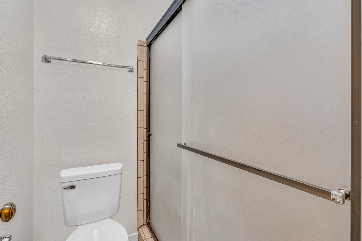 3350 M Street, Unit 74 Merced, CA 95348 - Photo 15 of 53 a white toilet sitting next to a shower curtain