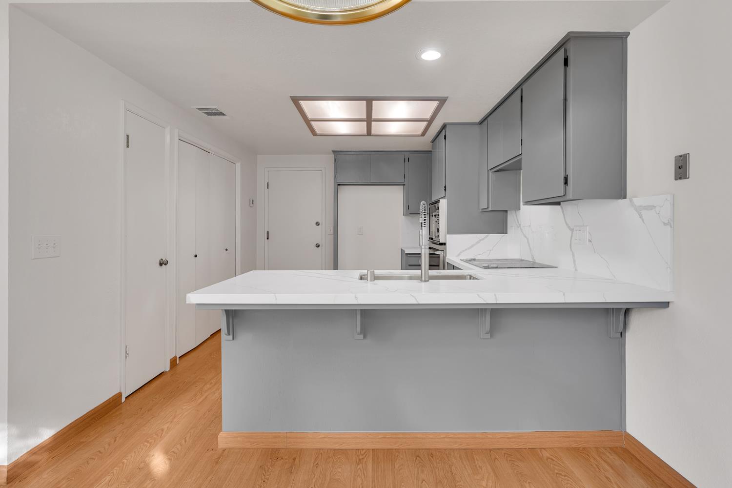 3350 M Street, Unit 74 Merced, CA 95348 - Photo 3 of 53 a kitchen with kitchen island a sink and a stove