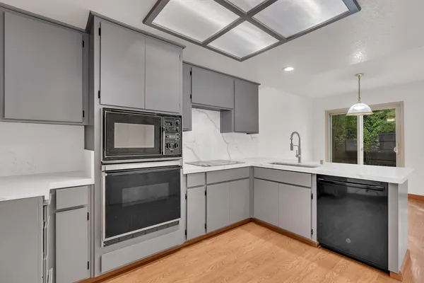 a kitchen with a sink cabinets and stainless steel appliances
