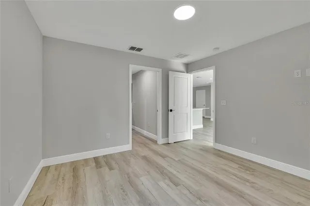 a view of an empty room and wooden floor