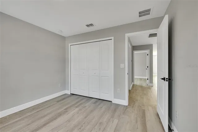 a view of a room with wooden floor