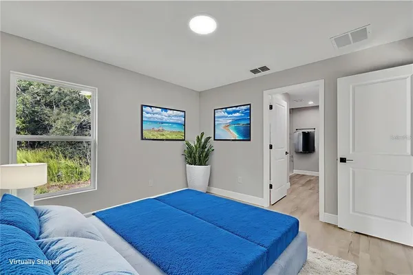 a bedroom with furniture and a window