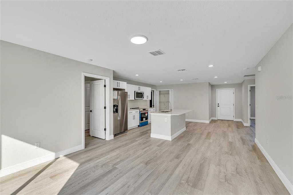 68 Water Track Loop Ocala, FL 34472 - Photo 10 of 20 a view of a big room with wooden floor and windows