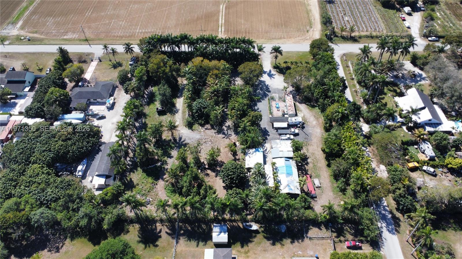 19355 Southwest 320th Street Homestead, FL 33030 - Photo 2 of 10 an aerial view of residential houses with outdoor space and trees