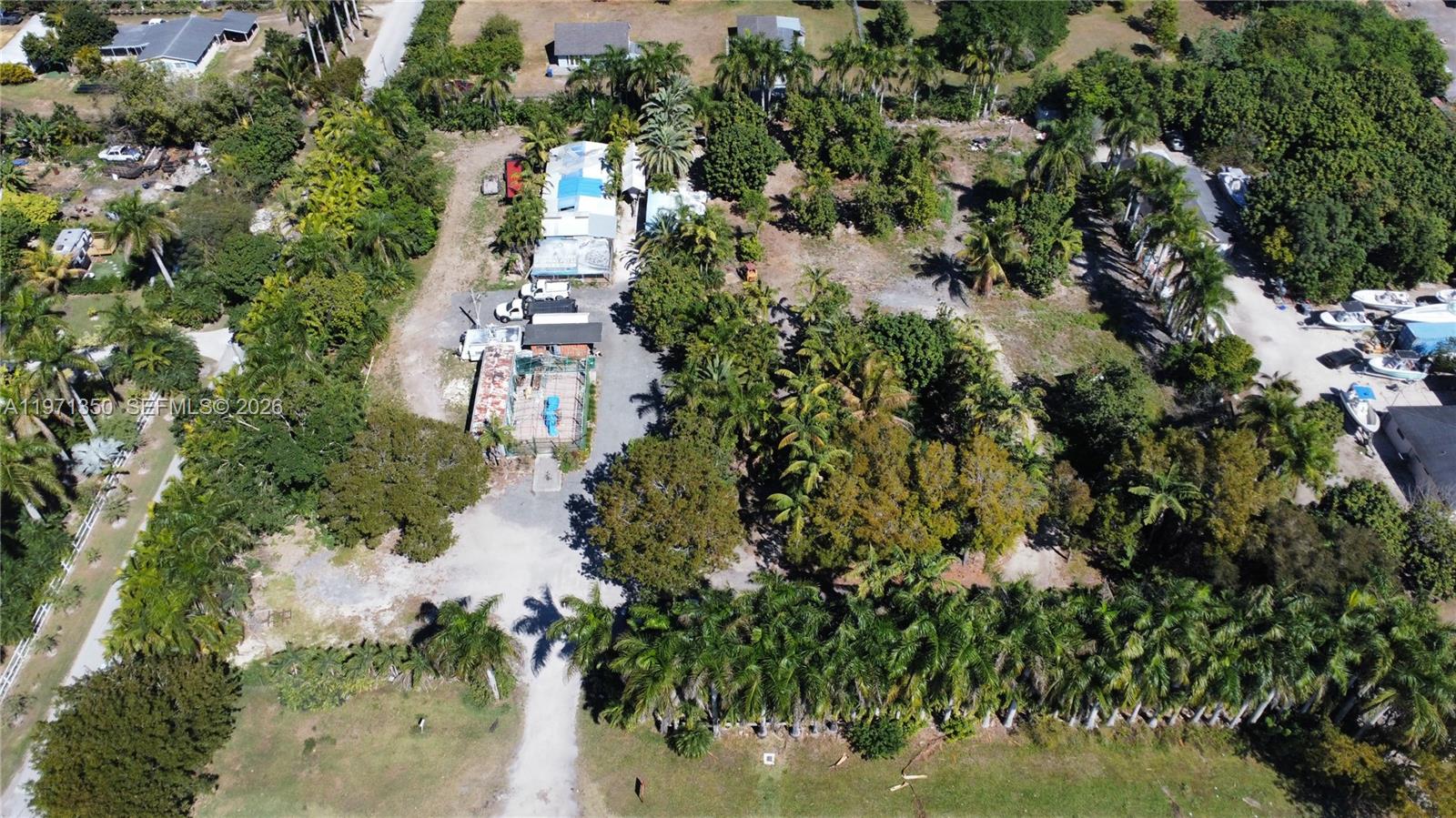 19355 Southwest 320th Street Homestead, FL 33030 - Photo 5 of 10 an aerial view of residential houses with outdoor space and trees