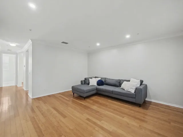 an empty room with a ceiling fan and a window