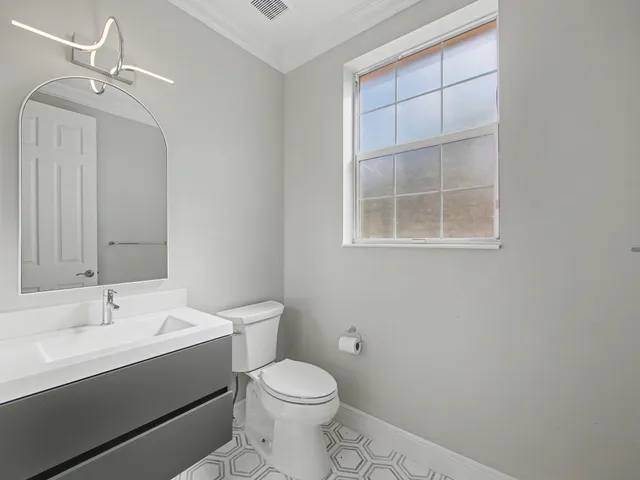 an empty room with a window and a ceiling fan