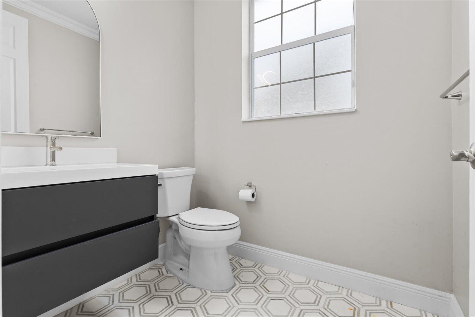 1460 Corbison Point Place Jupiter, FL 33458 - Photo 15 of 85 a bathroom with a sink toilet and window