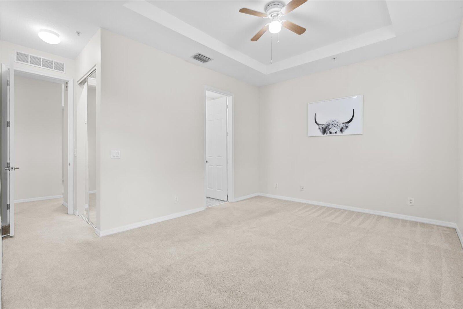 1460 Corbison Point Place Jupiter, FL 33458 - Photo 19 of 85 an empty room with a ceiling fan and a window