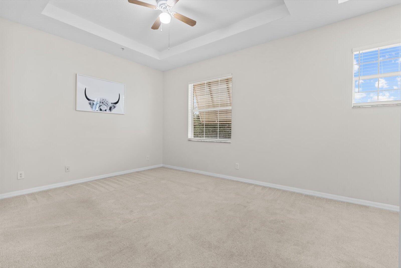 1460 Corbison Point Place Jupiter, FL 33458 - Photo 21 of 85 an empty room with a window and a ceiling fan