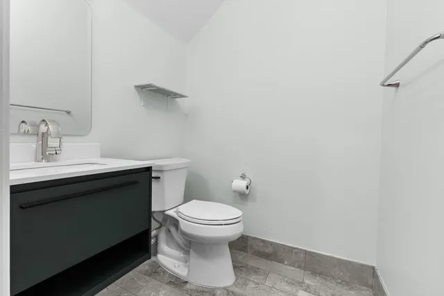 a bathroom with a sink toilet double vanity and shower