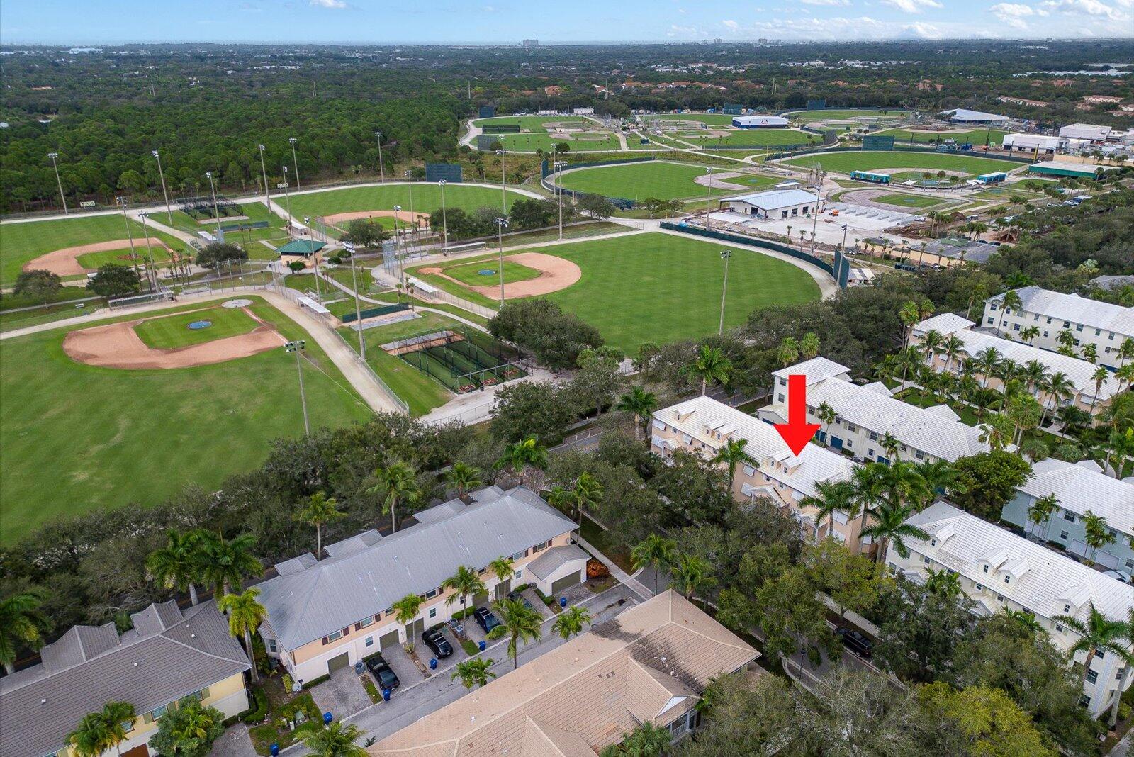 1460 Corbison Point Place Jupiter, FL 33458 - Photo 53 of 85 an aerial view of a house with a garden and lake view