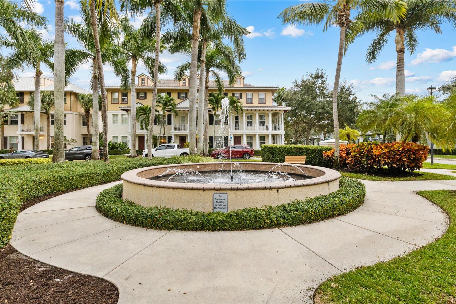 1460 Corbison Point Place Jupiter, FL 33458 - Photo 63 of 85 a view of a white house with a yard and palm trees
