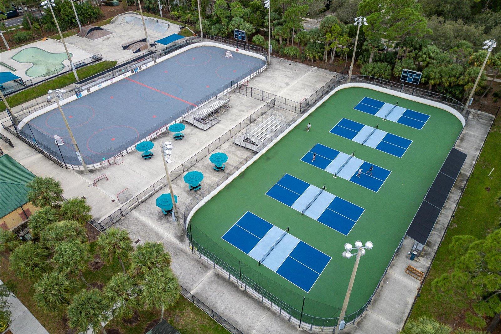 1460 Corbison Point Place Jupiter, FL 33458 - Photo 65 of 85 a view of a tennis ground with a white house