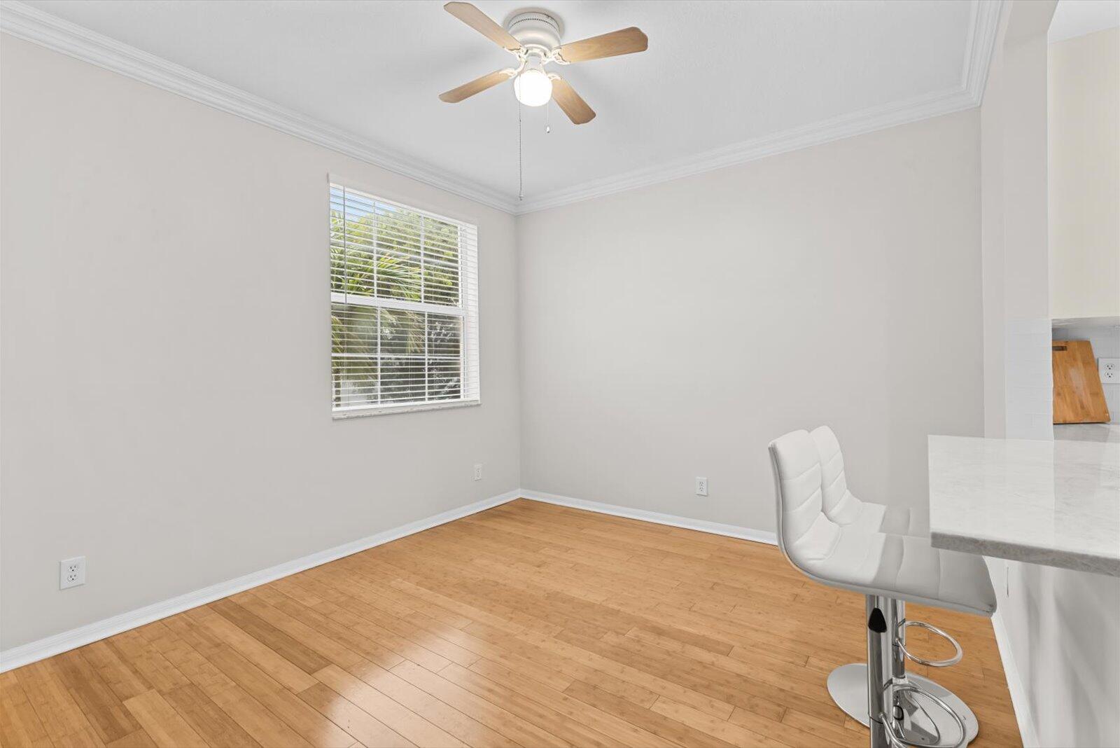 1460 Corbison Point Place Jupiter, FL 33458 - Photo 10 of 85 a view of a room with wooden floor and fan