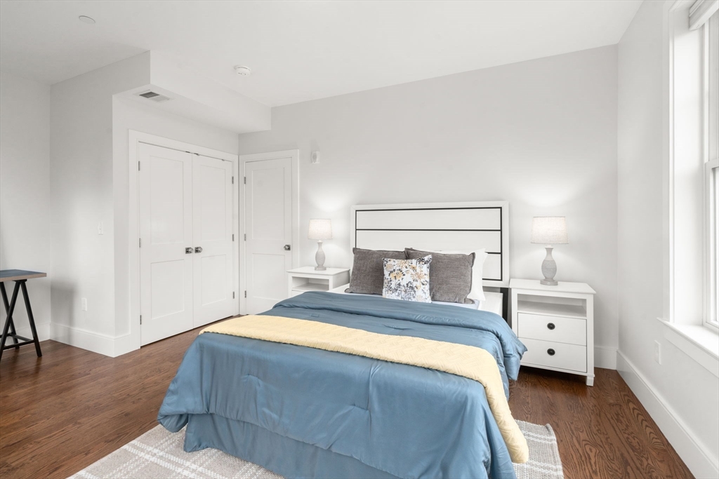 577 Baker Street, Unit 577 Boston, MA 02132 - Photo 13 of 22 a bedroom with a bed and a table