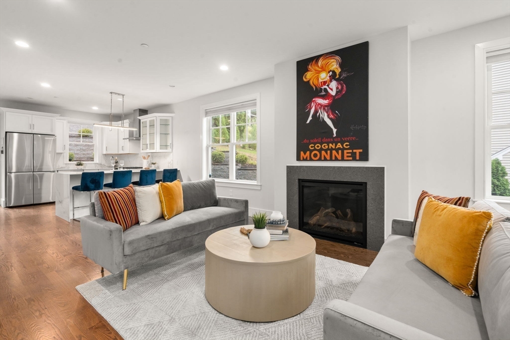 577 Baker Street, Unit 577 Boston, MA 02132 - Photo 2 of 22 a living room with furniture and a fireplace