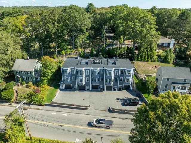 an aerial view of a house with swimming pool garden and tree