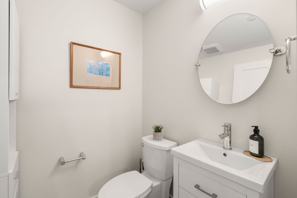 577 Baker Street, Unit 577 Boston, MA 02132 - Photo 8 of 22 a bathroom with a toilet sink and mirror